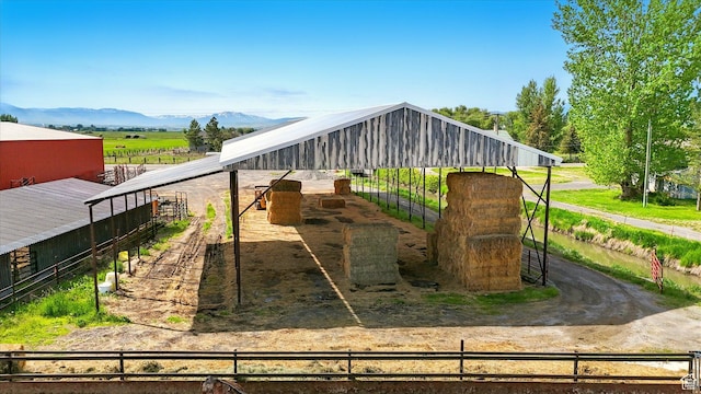 3703 W 600 S, Logan, UT 84321 - view of play area featuring an exterior structure, a mountain view, an outbuilding, and a view of rural / pastoral area