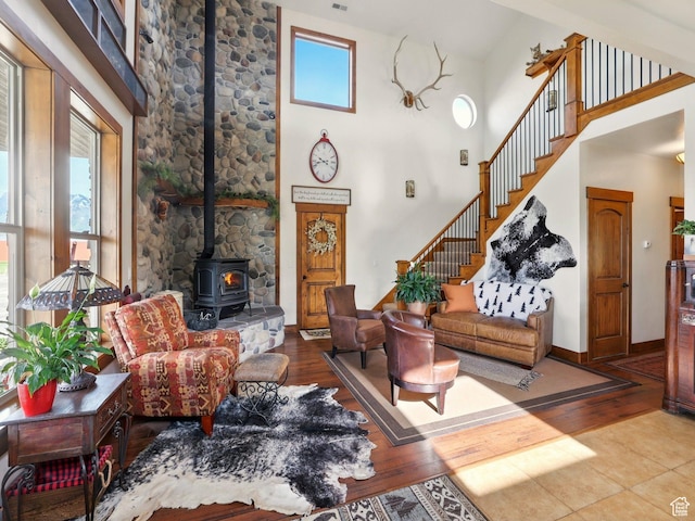3703 W 600 S, Logan, UT 84321 - living room featuring a wood stove, wood finished floors, stairs, and a high ceiling