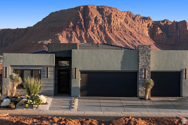 147 E Terrace Ln, Ivins, UT 84738 - view of front of home with a garage, stucco siding, driveway, and a mountain view