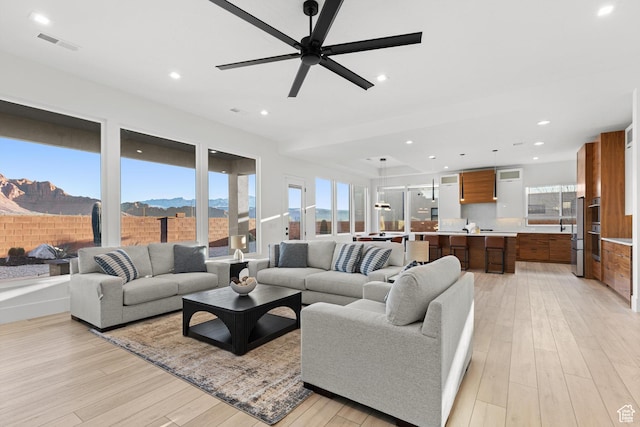147 E Terrace Ln, Ivins, UT 84738 - living area featuring light wood-style floors, a ceiling fan, a mountain view, and recessed lighting