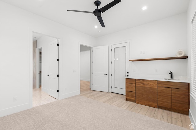 147 E Terrace Ln, Ivins, UT 84738 - unfurnished bedroom with light wood finished floors, bar with sink, recessed lighting, baseboards, and ceiling fan