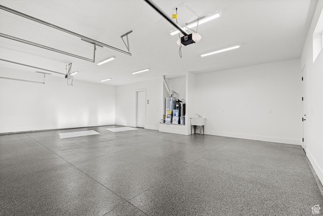 147 E Terrace Ln, Ivins, UT 84738 - garage with a garage door opener, baseboards, and gas water heater