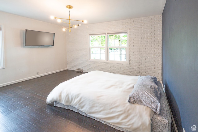 2848 S 500 E, South Salt Lake, UT 84106 - bedroom featuring a chandelier, wood finished floors, brick wall, and baseboards