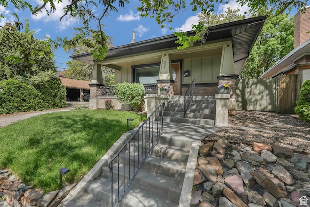 225 S 900 E, Salt Lake City, UT 84102 - view of front of home featuring a porch, a front lawn, stairway, and stone siding