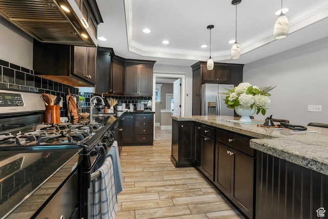 225 S 900 E, Salt Lake City, UT 84102 - kitchen featuring stainless steel appliances, wall chimney range hood, crown molding, tasteful backsplash, and light stone counters