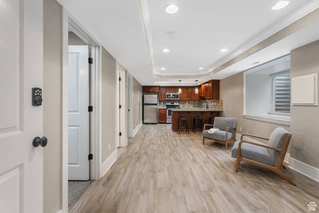 225 S 900 E, Salt Lake City, UT 84102 - living room with light wood-type flooring, baseboards, a raised ceiling, and recessed lighting