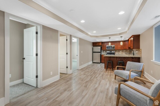 225 S 900 E, Salt Lake City, UT 84102 - living area featuring light wood-style floors, baseboards, a tray ceiling, and recessed lighting