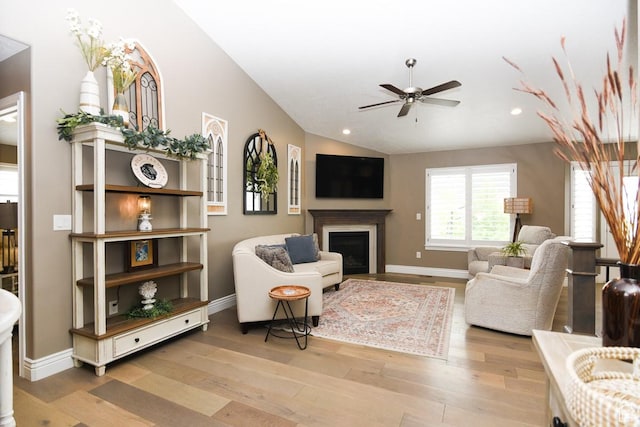 living area with a ceiling fan, wood finished floors, recessed lighting, a fireplace, and baseboards