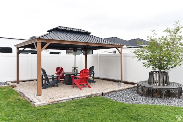 view of patio / terrace featuring a gazebo and a fire pit
