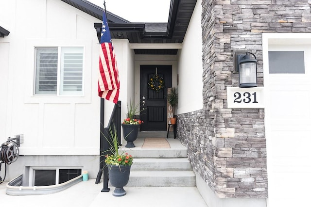 doorway to property with stone siding and stucco siding