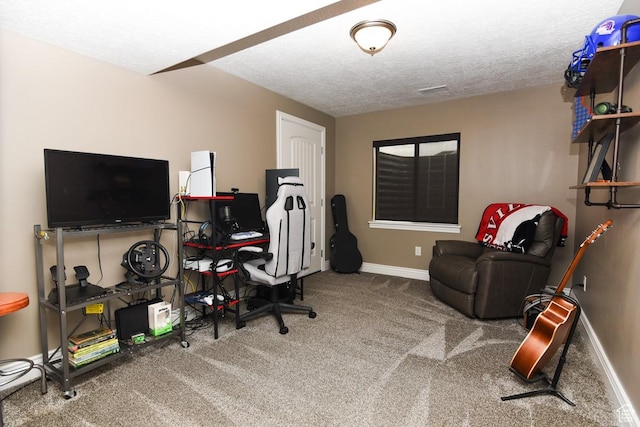 office space featuring carpet floors, baseboards, and a textured ceiling