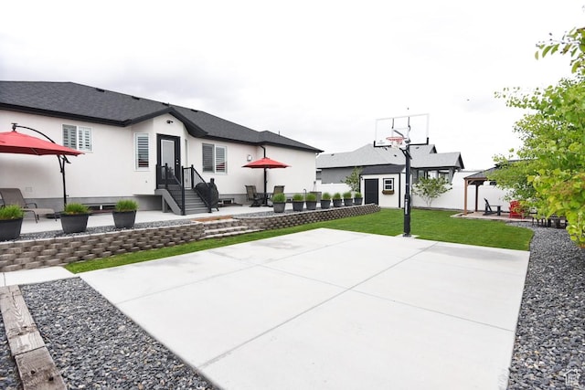 view of sport court with a gazebo and a lawn