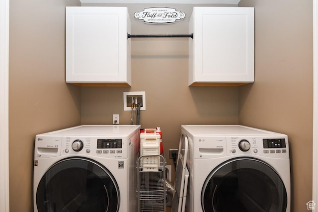 washroom featuring cabinet space and washer and dryer