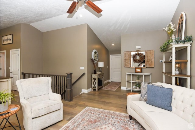 living room with a ceiling fan, wood finished floors, baseboards, and recessed lighting