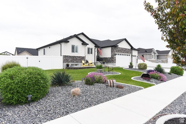 view of front of house with stone siding, an attached garage, and stucco siding