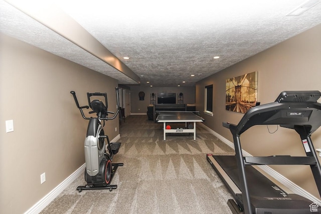 workout room featuring carpet, recessed lighting, baseboards, and a textured ceiling