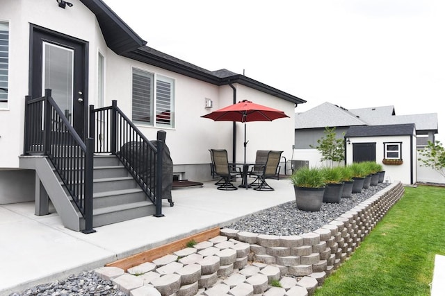 view of patio / terrace with cooling unit and an outbuilding