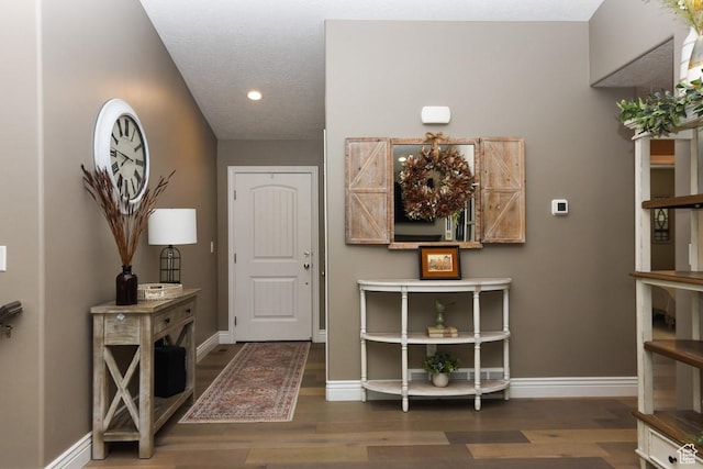 entrance foyer with wood finished floors, recessed lighting, and baseboards