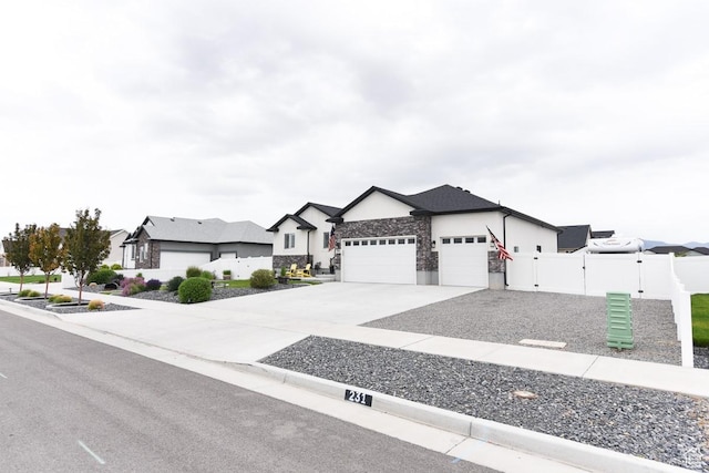 single story home with a garage, fence, concrete driveway, a gate, and stucco siding