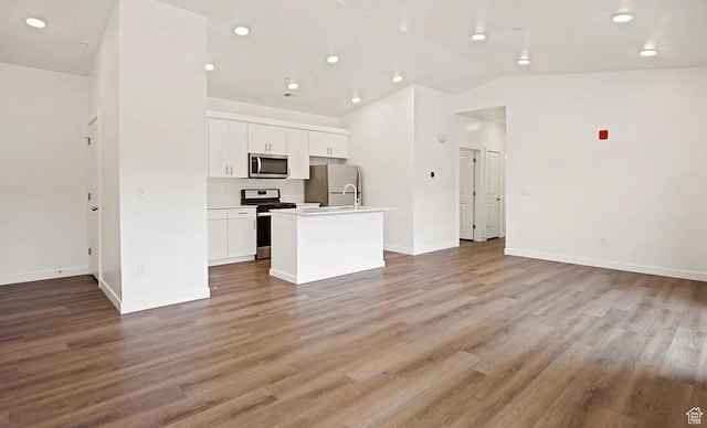 473 W 40 S Unit H 204, Providence, UT 84332 - unfurnished living room with vaulted ceiling, wood finished floors, baseboards, and recessed lighting