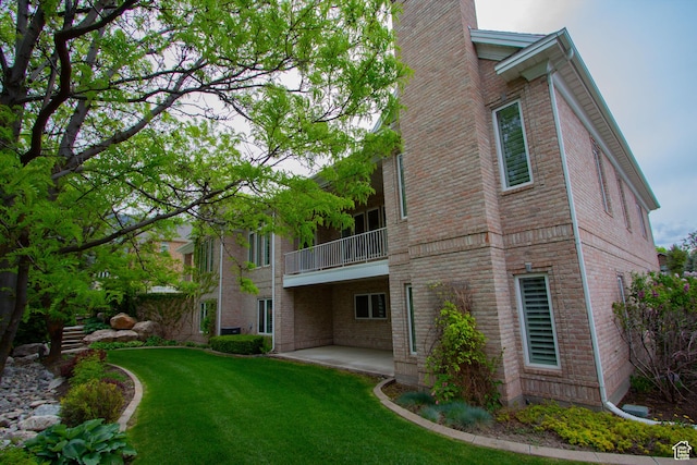 1315 E 1550 N, North Logan, UT 84341 - back of property with a balcony, brick siding, a patio area, a yard, and a chimney