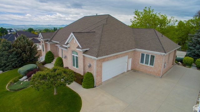 1315 E 1550 N, North Logan, UT 84341 - view of front of house with brick siding, roof with shingles, a garage, concrete driveway, and a front yard