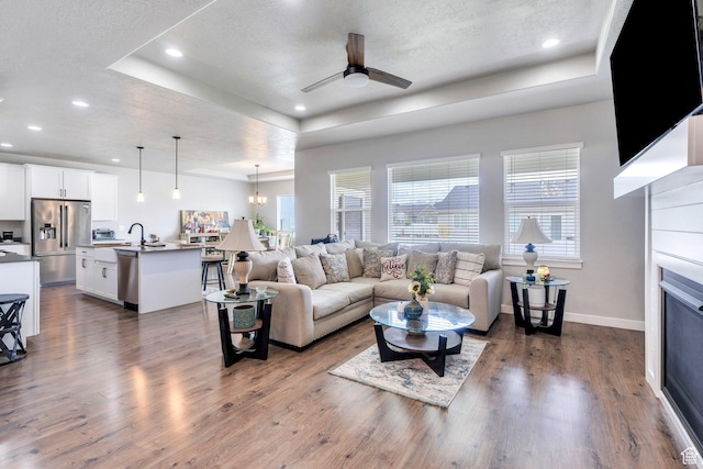 701 S Crooket Post Way W, Saratoga Springs, UT 84045 - living area featuring a tray ceiling, ceiling fan, dark wood-style flooring, a textured ceiling, and recessed lighting