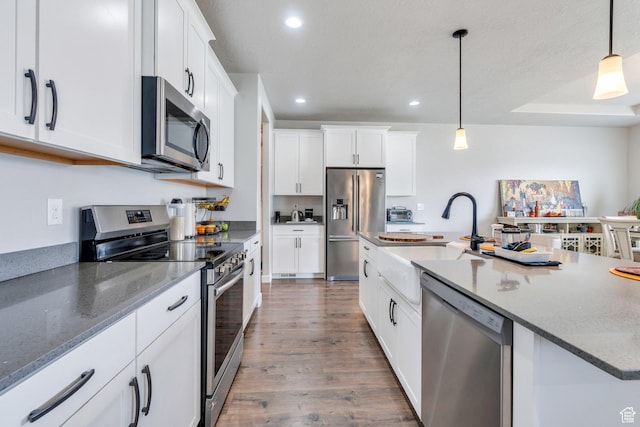 701 S Crooket Post Way W, Saratoga Springs, UT 84045 - kitchen featuring stainless steel appliances, recessed lighting, a sink, wood finished floors, and white cabinets