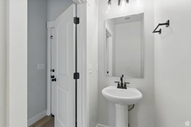 bathroom featuring baseboards and wood finished floors