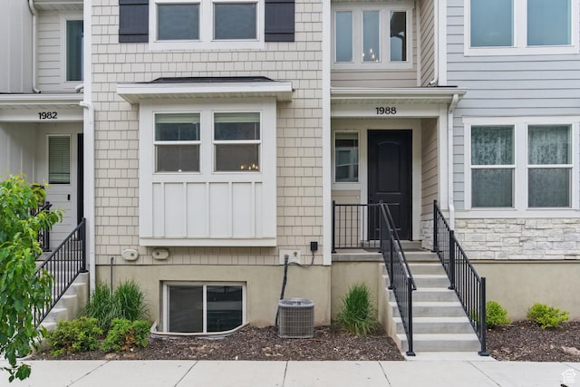 entrance to property with central AC and stone siding