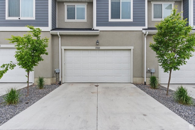garage featuring concrete driveway