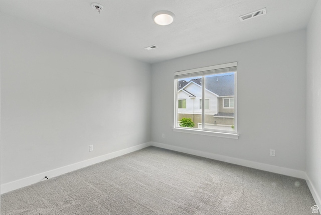 empty room with baseboards, carpet flooring, and fire sprinkler in ceiling