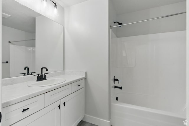 full bath featuring  shower combination, baseboards, and vanity