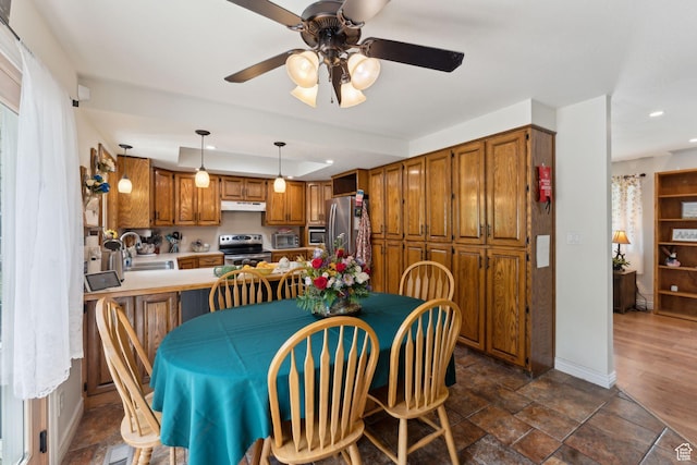 dining area with a ceiling fan, recessed lighting, baseboards, and dark stone finish flooring