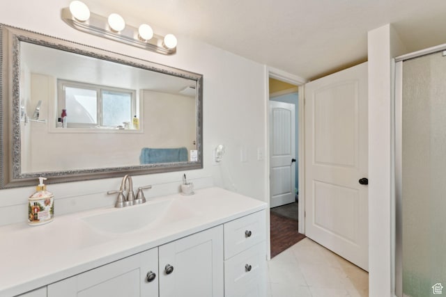 full bathroom with vanity, tile patterned flooring, and an enclosed shower