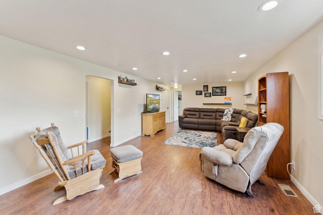 living area with wood finished floors, recessed lighting, and baseboards