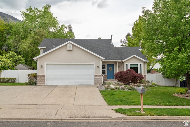 view of front of property featuring a garage, driveway, brick siding, roof with shingles, and stucco siding