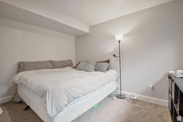 carpeted bedroom featuring baseboards