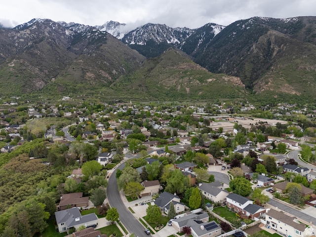 aerial view of property's location featuring a mountain backdrop and nearby suburban area