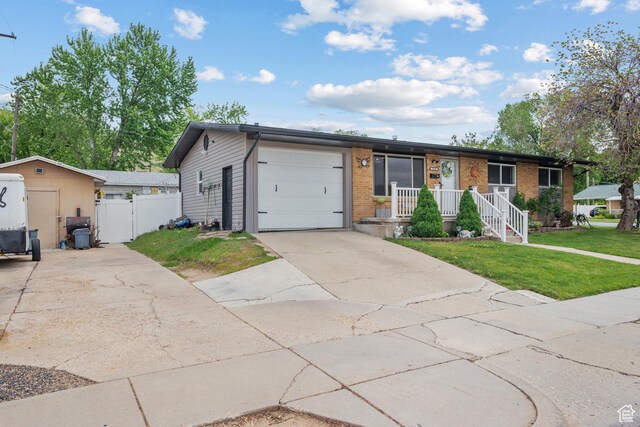 1414 N 325 E, Bountiful, UT 84010 - ranch-style house with a garage, driveway, brick siding, and covered porch