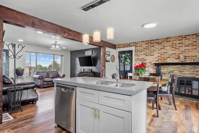 1414 N 325 E, Bountiful, UT 84010 - kitchen with stainless steel dishwasher, a sink, open floor plan, wood finished floors, and a textured ceiling