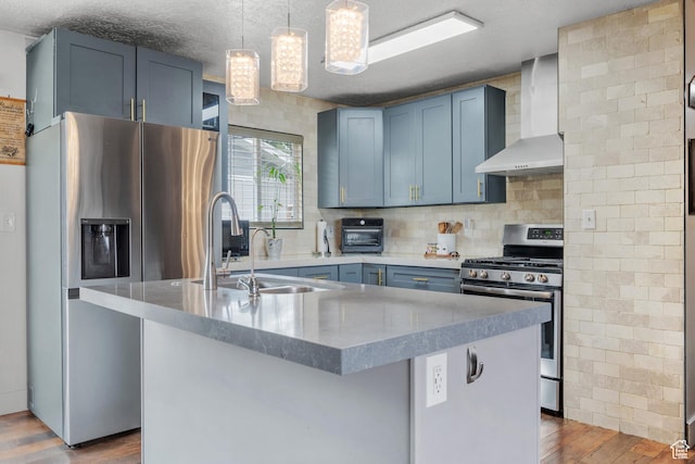 1414 N 325 E, Bountiful, UT 84010 - kitchen featuring wall chimney exhaust hood, appliances with stainless steel finishes, a sink, wood finished floors, and tasteful backsplash