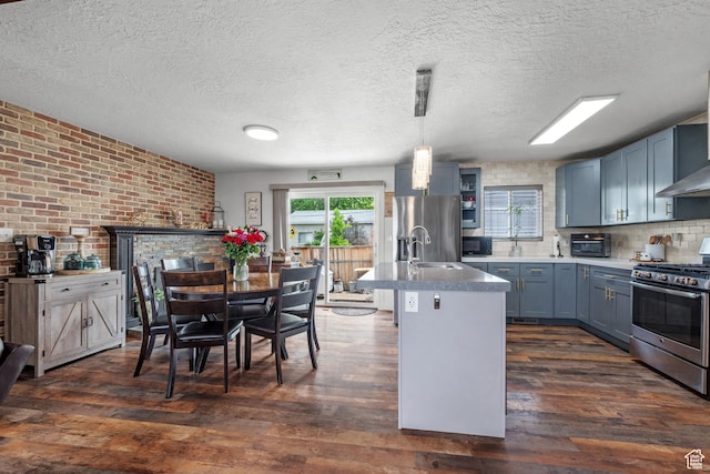 1414 N 325 E, Bountiful, UT 84010 - kitchen with appliances with stainless steel finishes, dark wood finished floors, brick wall, a textured ceiling, and blue cabinetry