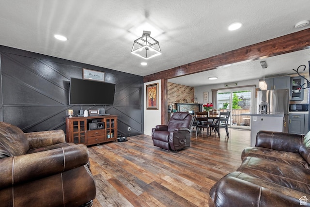 1414 N 325 E, Bountiful, UT 84010 - living room with wood finished floors, a textured ceiling, a decorative wall, and recessed lighting