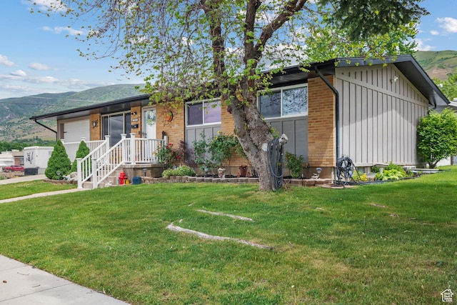 1414 N 325 E, Bountiful, UT 84010 - view of front of property with board and batten siding, a mountain view, a front lawn, and brick siding