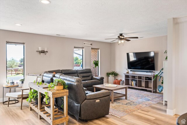 851 E Posado St, Ivins, UT 84738 - living area featuring healthy amount of natural light, ceiling fan, a textured ceiling, light wood-style flooring, and baseboards