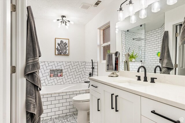 851 E Posado St, Ivins, UT 84738 - full bathroom with a relaxing tiled tub, a tile shower, vanity, tile patterned floors, and toilet