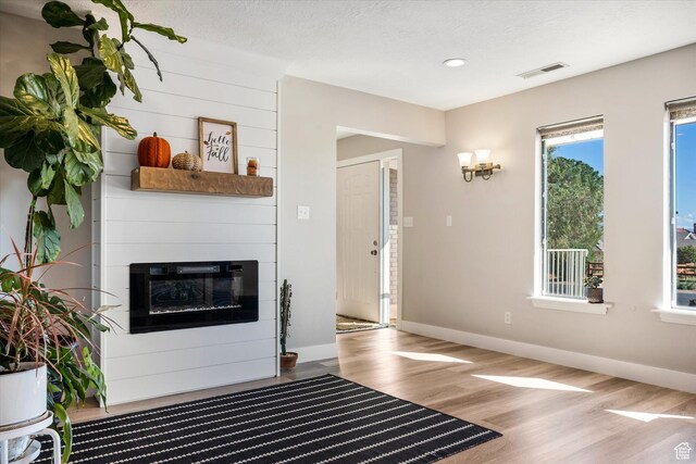 851 E Posado St, Ivins, UT 84738 - living room with wood finished floors, baseboards, a fireplace, recessed lighting, and a textured ceiling