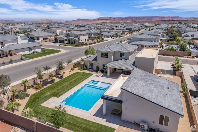2938 S Poplar Ln, St George, UT 84790 - view of swimming pool with a residential view, a mountain view, and a pool with connected hot tub