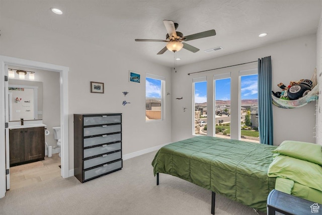 2938 S Poplar Ln, St George, UT 84790 - bedroom with light carpet, baseboards, recessed lighting, a sink, and ensuite bath